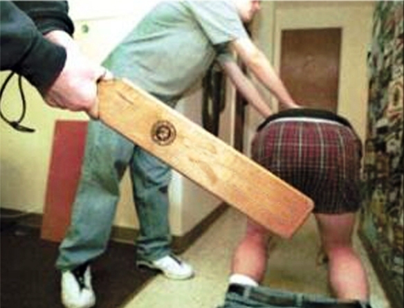 photo of person getting whacked on his behind with a board