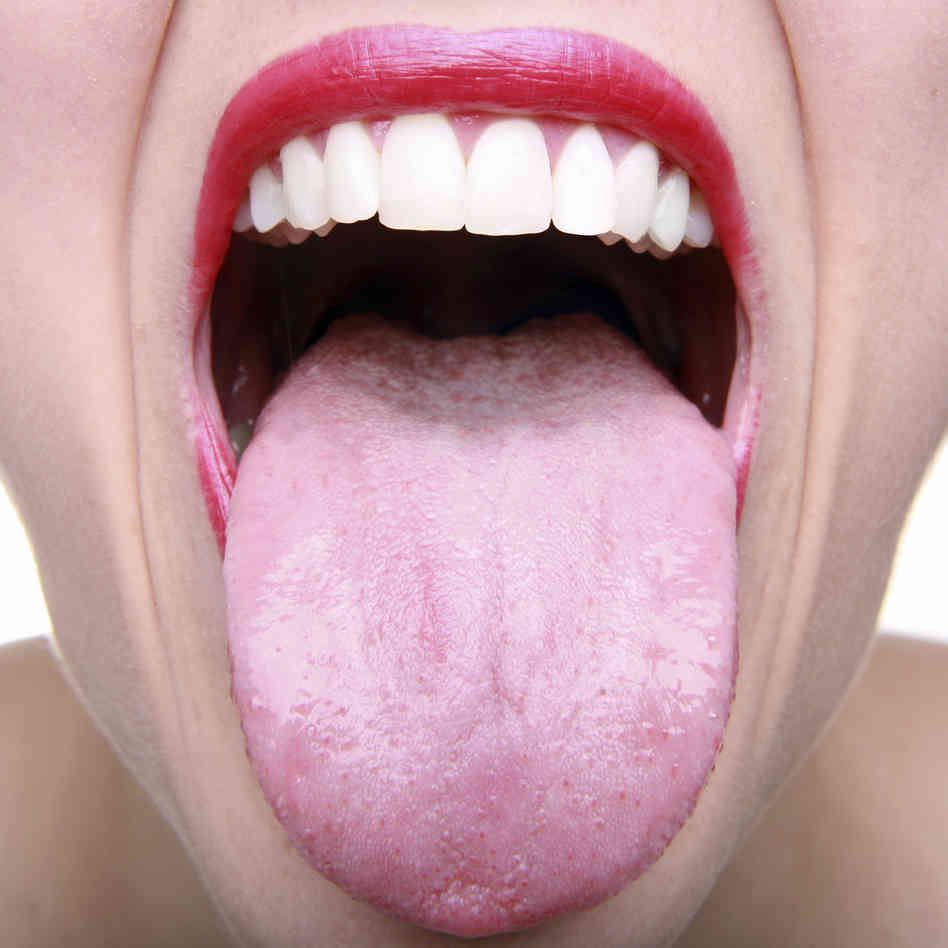 photo of closeup of someone sticking their tongue out