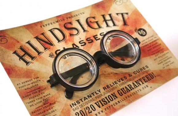 glasses sitting on a flier that says "hindsight"