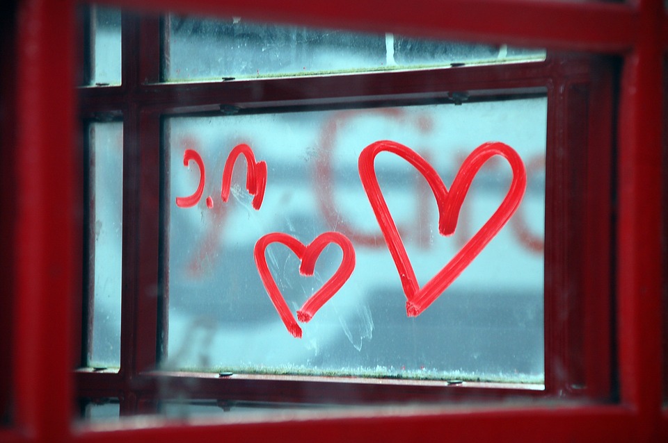 image of red hearts drawn in a window