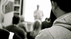 lecturer and students in black and white photo